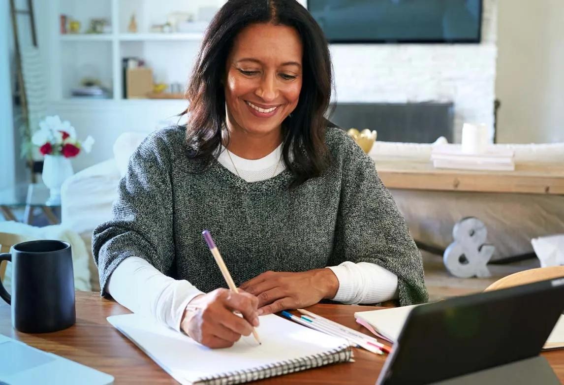 healthcare job applicant writing a thank you email on a laptop after an interview