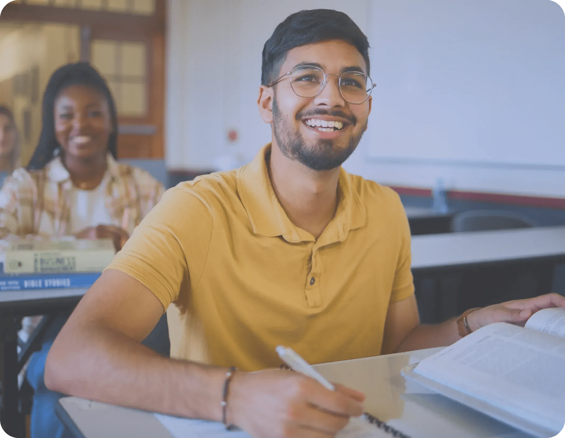 man wearing glasses learning in a classroom