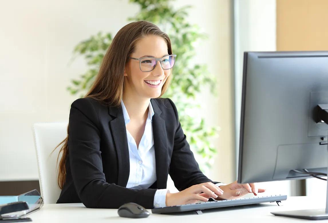 a lady wearing glasses typing