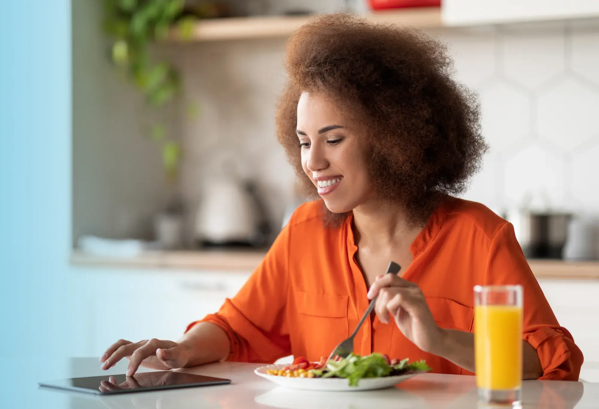 an adult learner eating a healthy breakfast as part of a daily routine while completing her healthcare program
