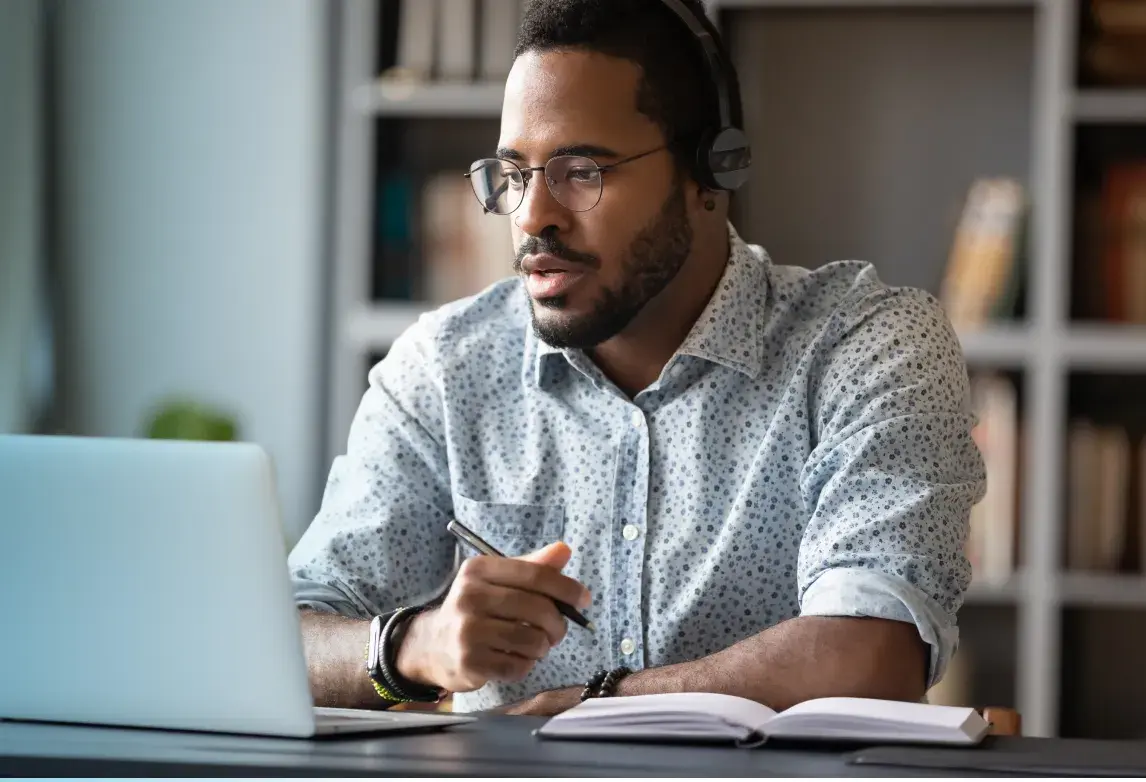 a man working on his medical transcription skills after completing a healthcare training program