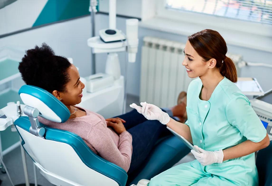 dental assistant working in a dentist's office after completing a dental assistant program