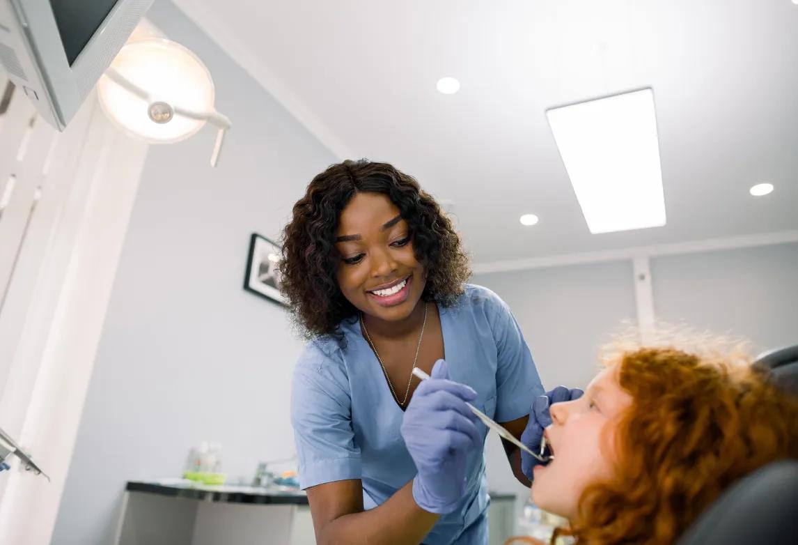 dental assistant with expanded functions assisting a dentist with a patient procedure