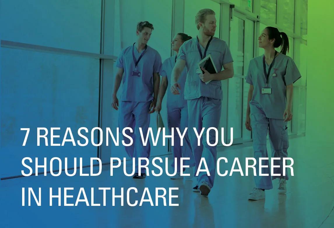 Healthcare workers in scrubs walk down a hallway in a hospital setting.