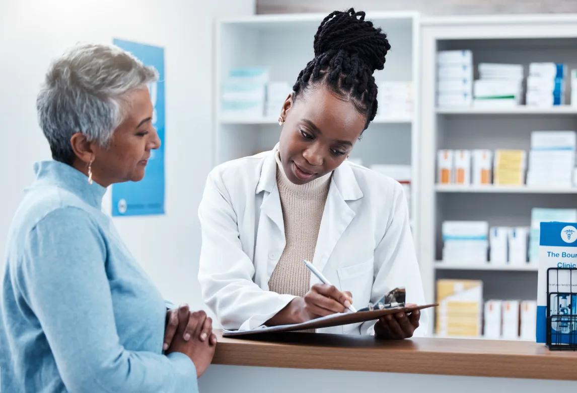 a pharmacy technician talking to patient