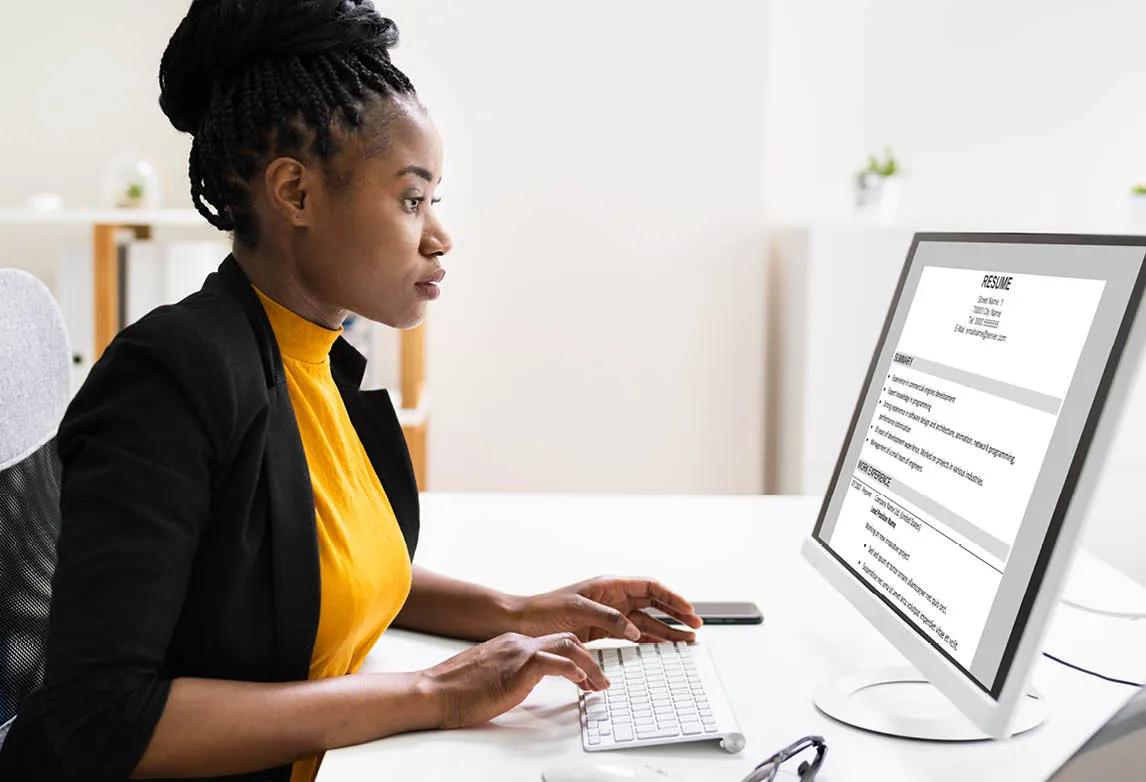 new grad holding a healthcare resume in front of her chest