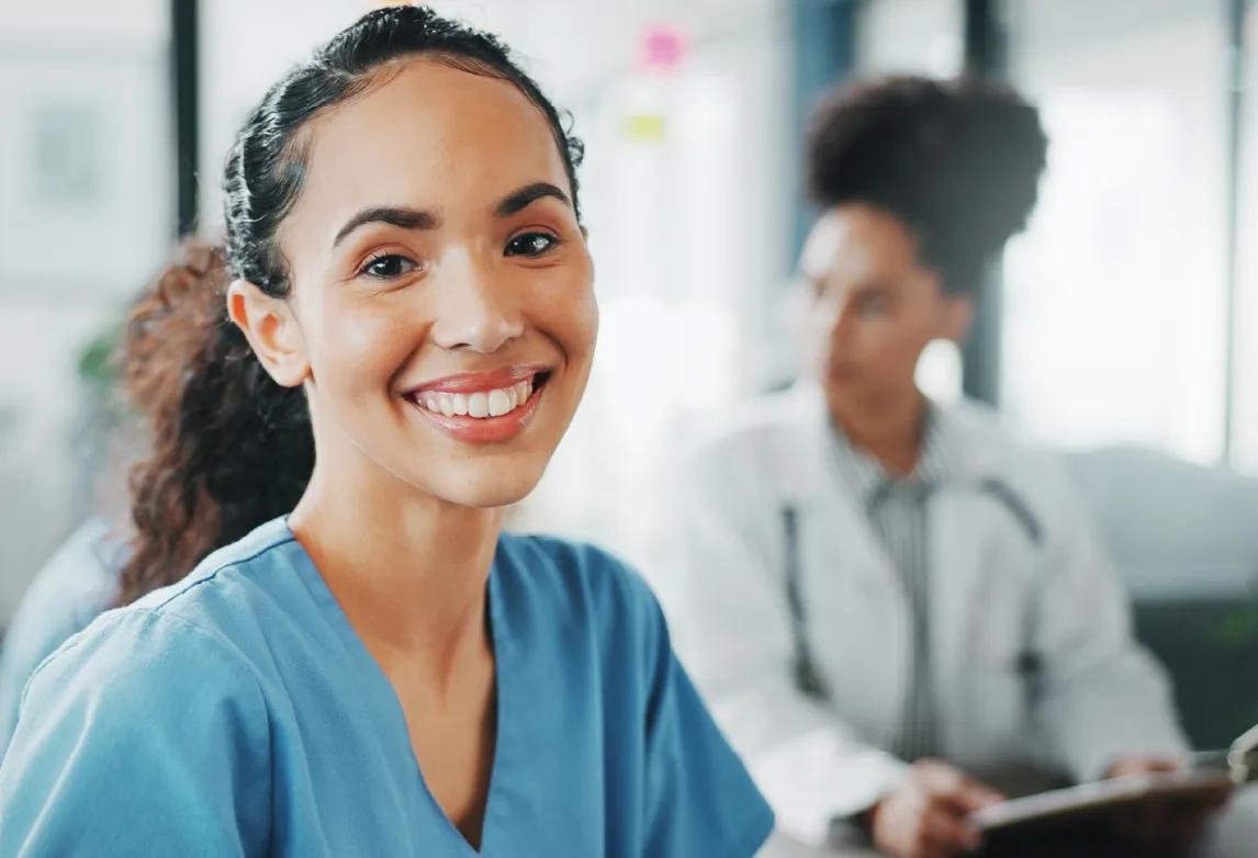 hiring manager pointing at a board with sticky notes while talking with healthcare job candidates