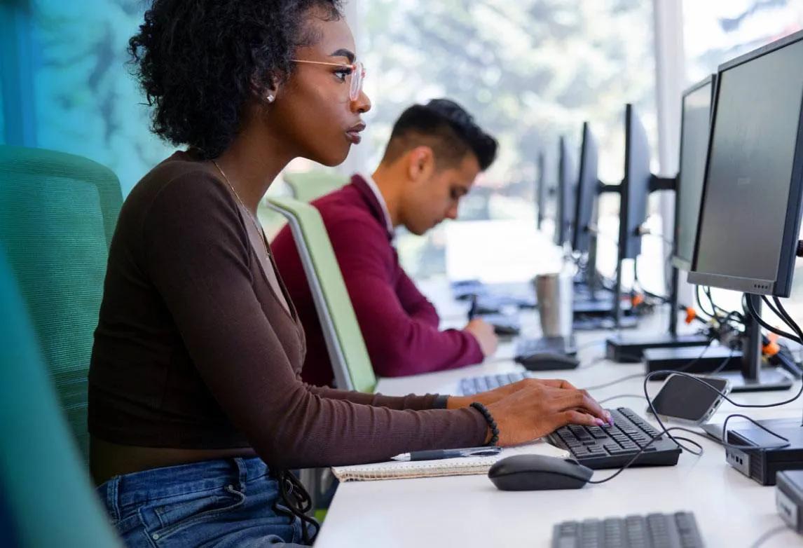 A woman works ona. computer at a desk