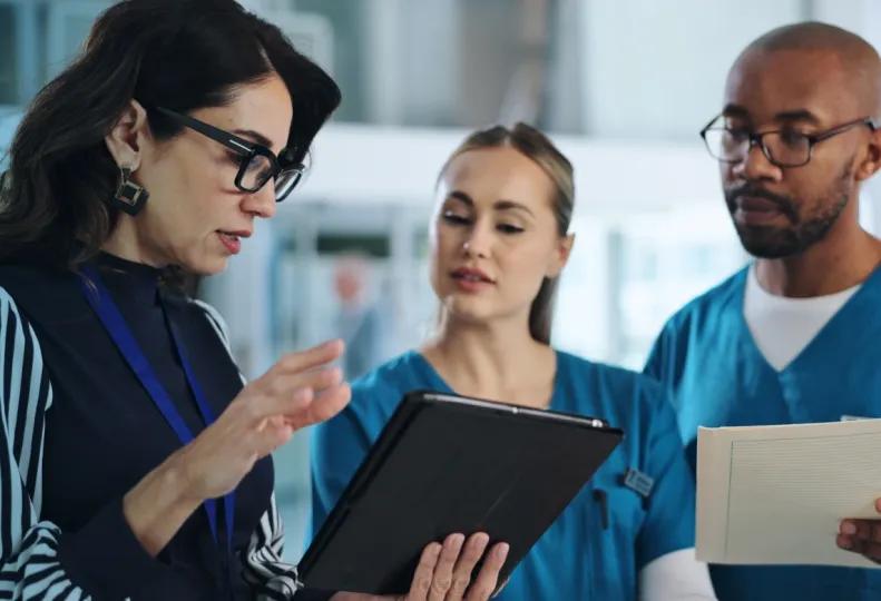 a healthcare management career professional working with employees after completing a healthcare management program