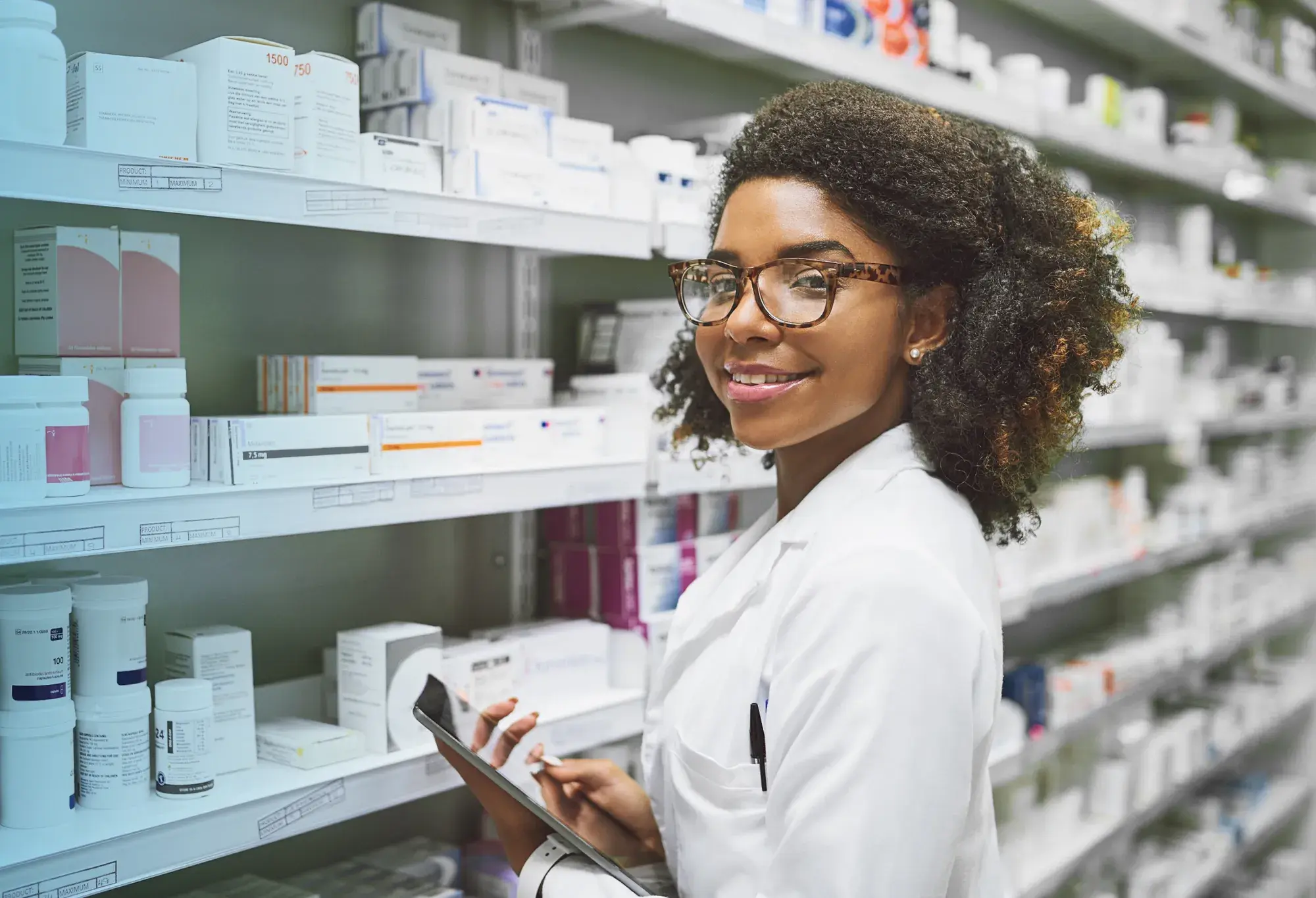 a pharmacy technician checking inventory after getting her pharmacy technician certification through the Pharmacy Technician Certification Board