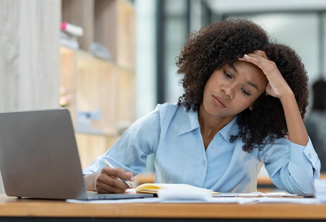 A student looking overwhelmed while studying