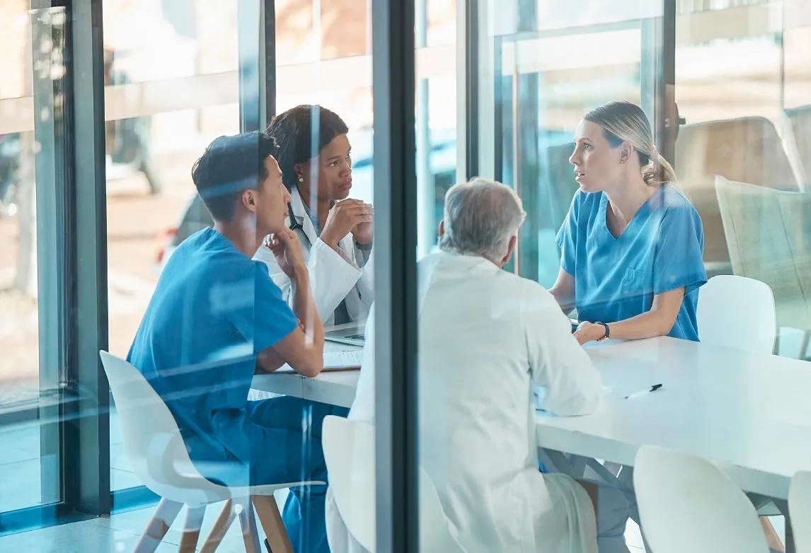 four clinical prople in a meeting room